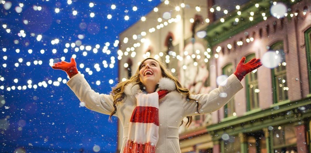 Woman surrounded by Christmas lights