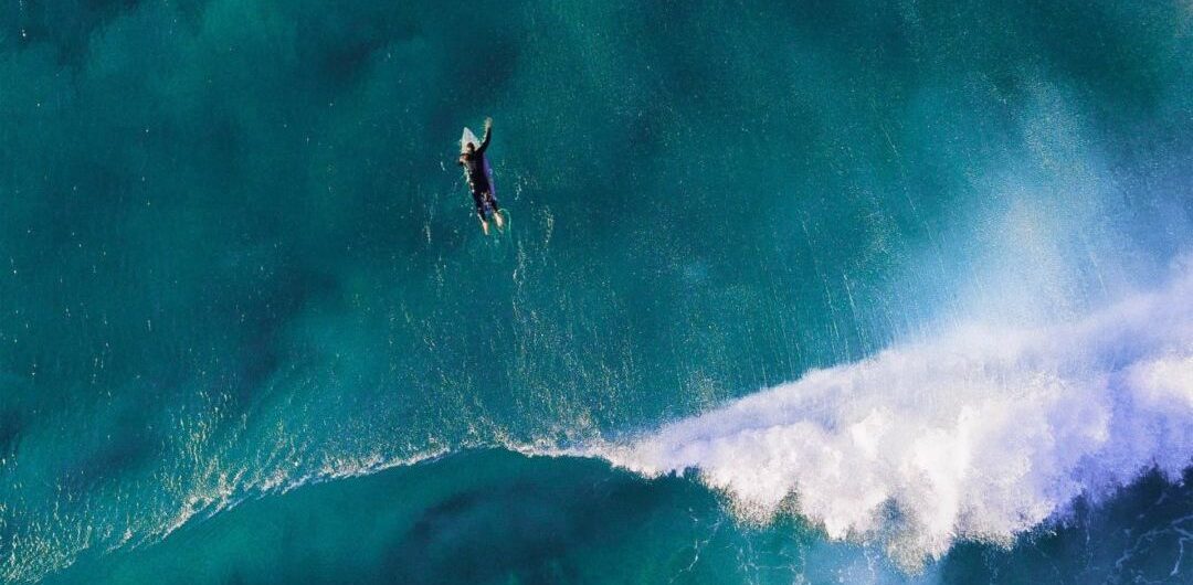 Surfer paddling out in the ocean