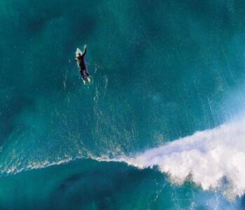 Surfer paddling out in the ocean