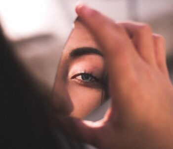 reflection of woman s eye on broken mirror