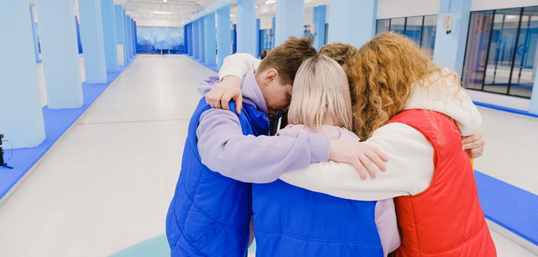 hugging unrecognizable group of people in spacious arena