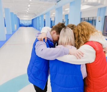 hugging unrecognizable group of people in spacious arena