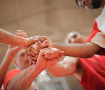 basketball team stacking hands together