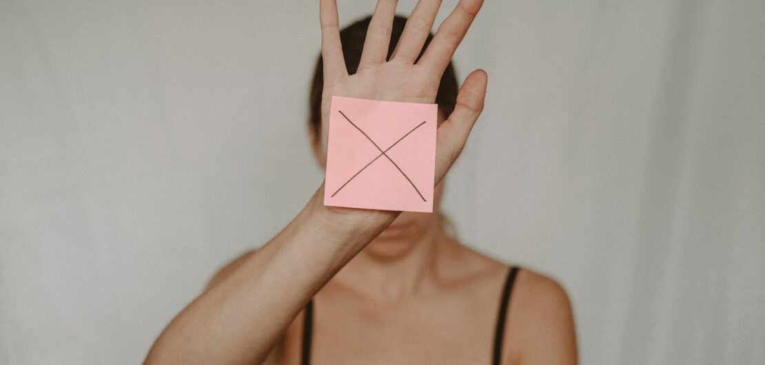 woman showing paper with prohibition sign