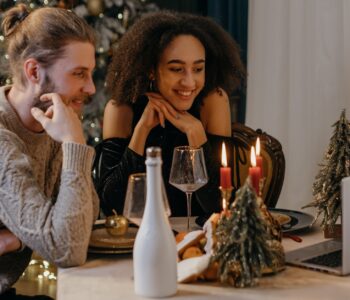 couple sitting at table looking at the laptop