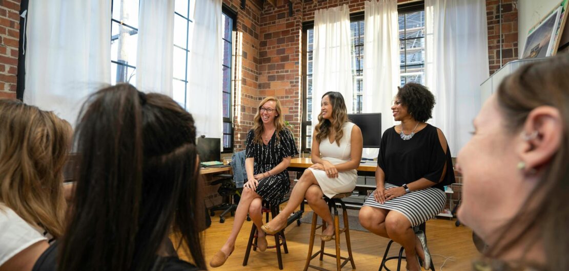 women sitting on chairs inside a room