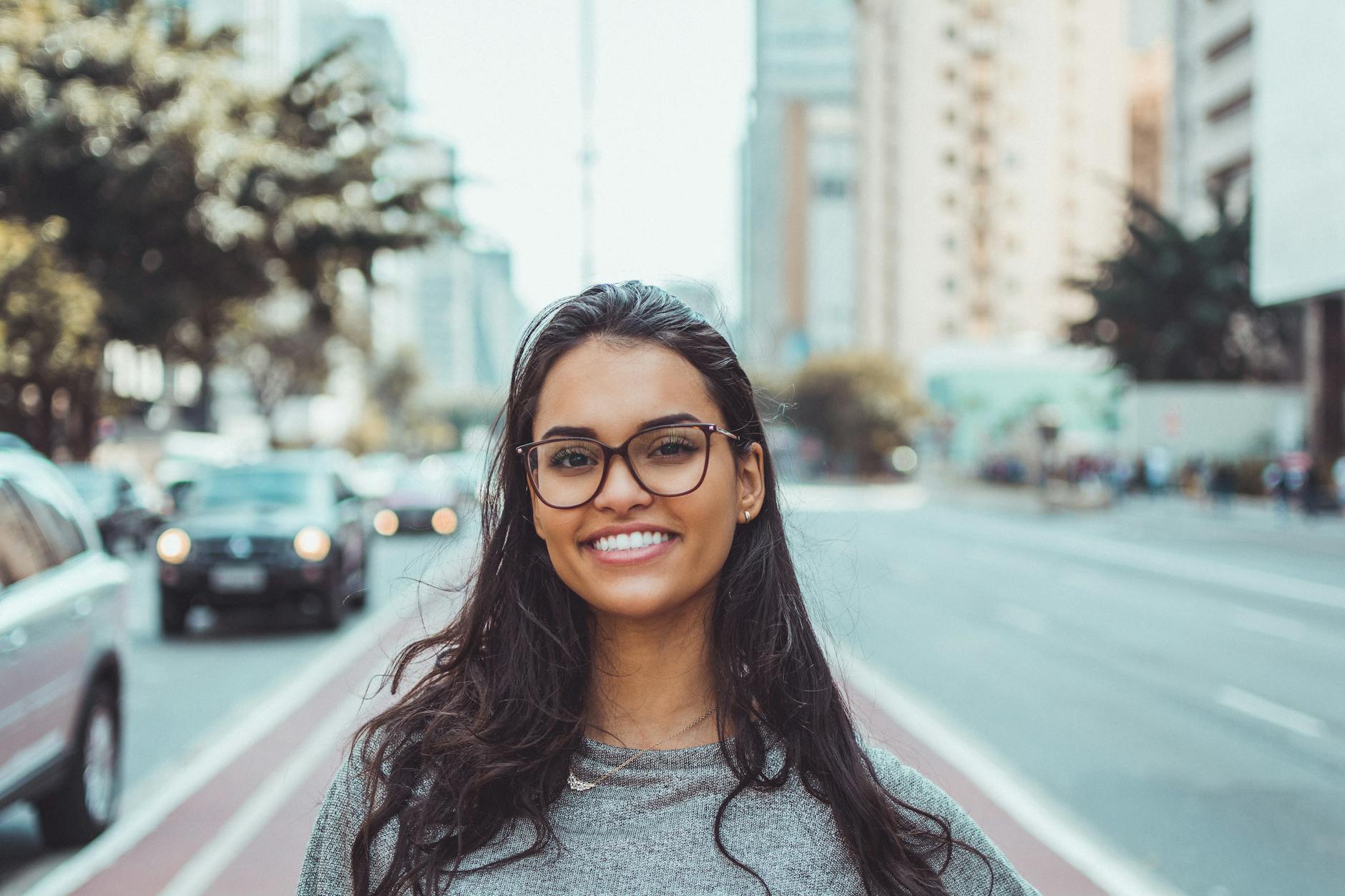 woman wearing black eyeglasses, smiling